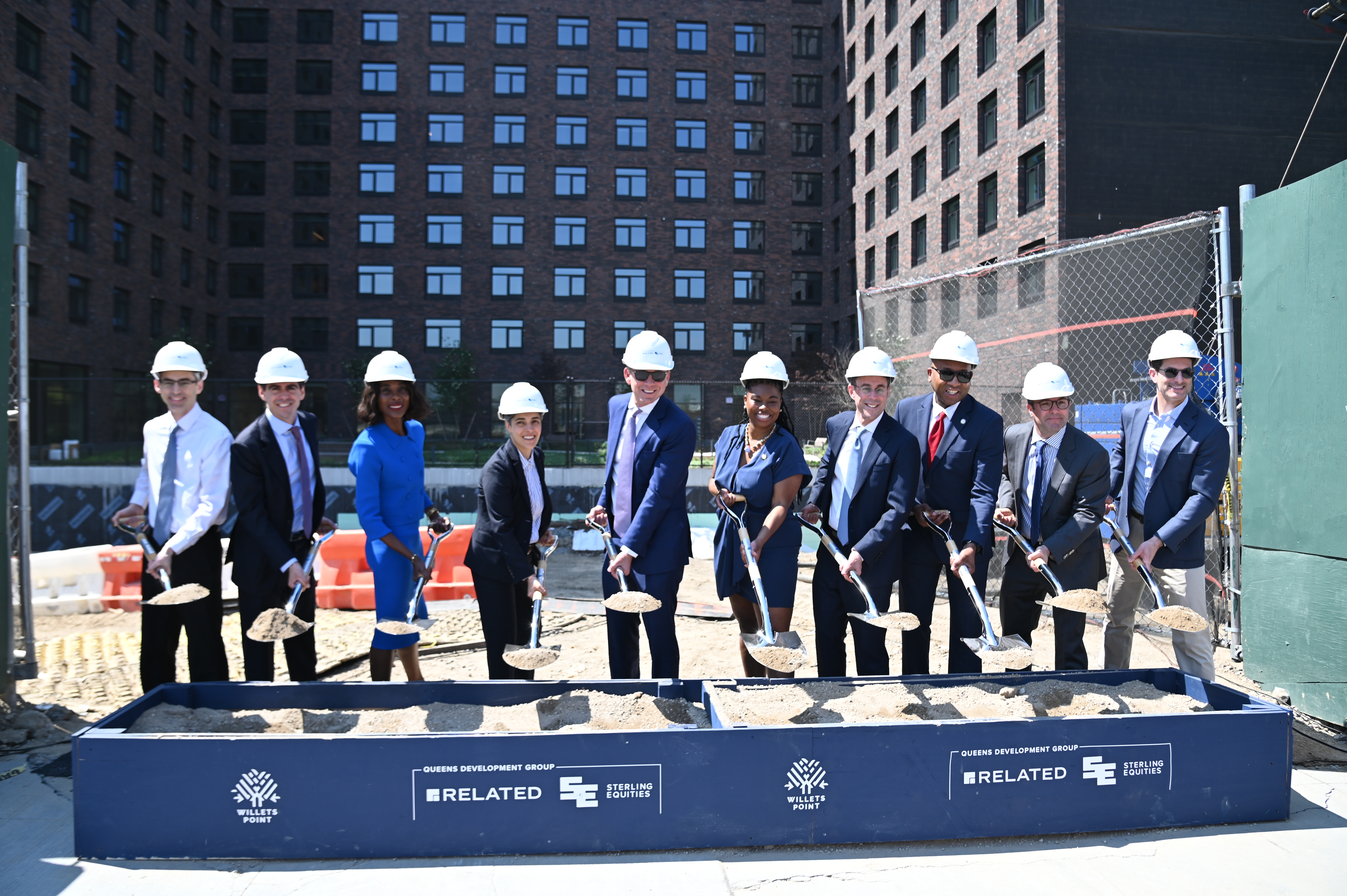 image of group of public and private partners, breaking ground with shovels of phase three of Willets Point housing