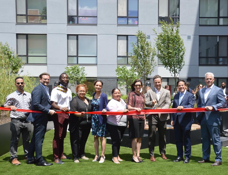 City Officials and Project Partners at the ribbon cutting celebration for 50 Penn affordable housing