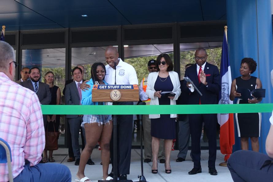 mayor Adams at podium with tenant at Beach 21, Far Rockaway 