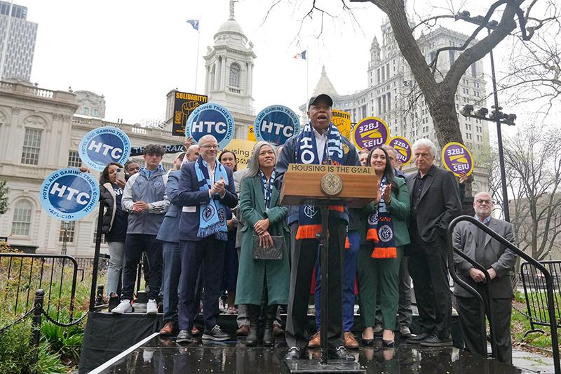 Mayor Adams and partners in front of city hall 