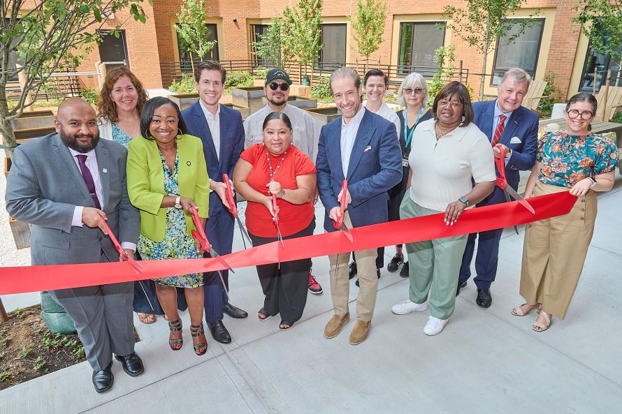 city and private representatives cutting the ribbon on new affordable housing
