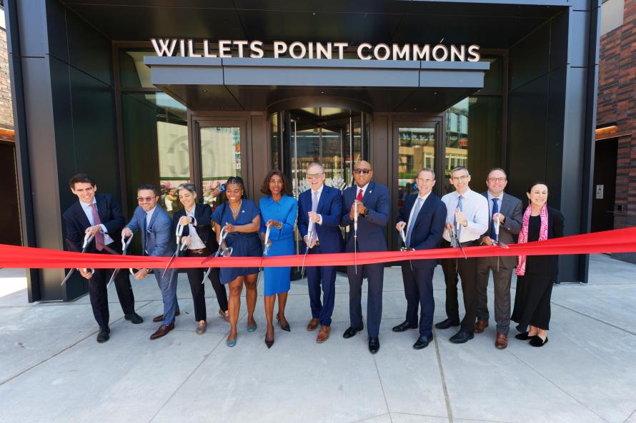 image of group of public and private partners cutting the red ribbon commemorating the opening of Willets Points Phase 1 and 2 