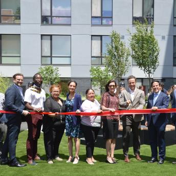 City Officials and Project Partners at the ribbon cutting celebration for 50 Penn affordable housing