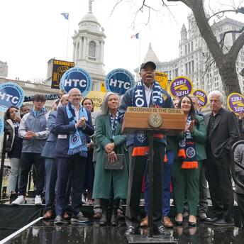 Mayor Adams and partners in front of city hall 