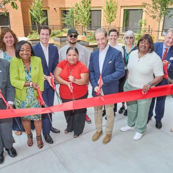city and private representatives cutting the ribbon on new affordable housing