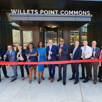 image of group of public and private partners cutting the red ribbon commemorating the opening of Willets Points Phase 1 and 2 