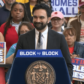 Mayor Mamdani standing in front of a crowd of supporters to announce his administration's housing plan, Block by Block